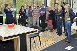 Groep ambtenaren kijken naar vellen teksten op de grond